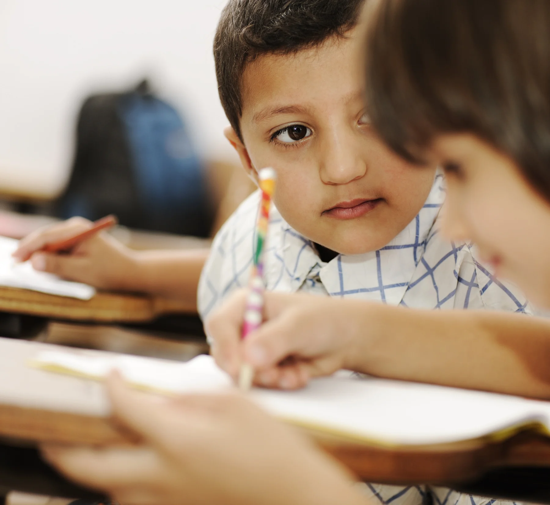 A child focused on learning and early writing